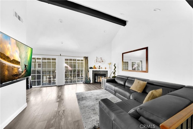 living room featuring a fireplace, visible vents, wood finished floors, high vaulted ceiling, and beamed ceiling