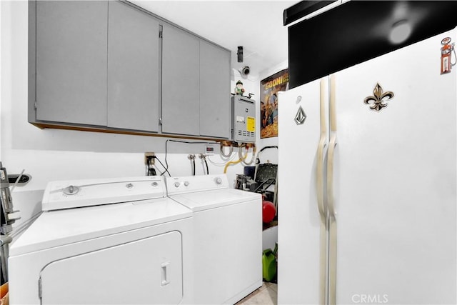 clothes washing area featuring washer and dryer, laundry area, and water heater