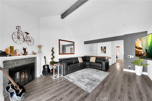 living room featuring baseboards, wood finished floors, a fireplace, high vaulted ceiling, and beam ceiling