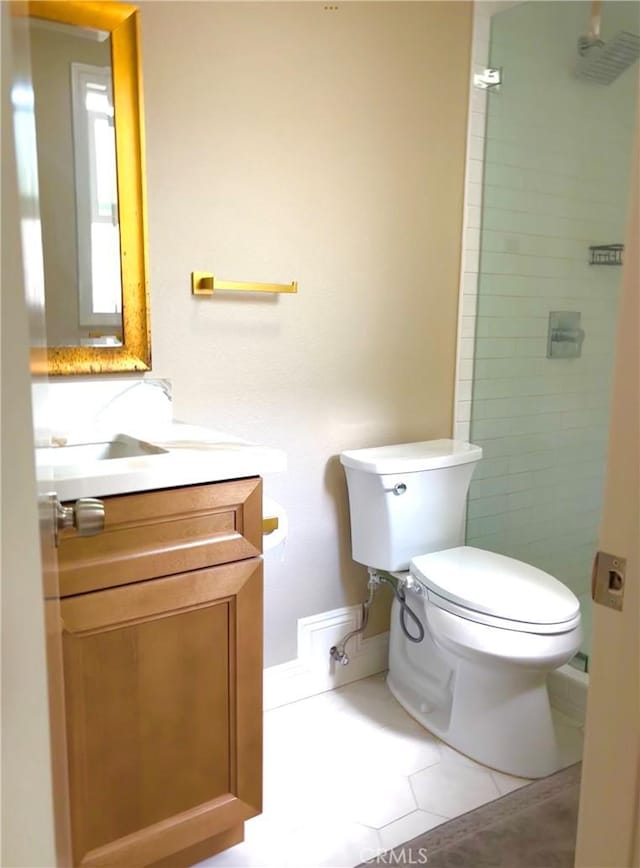 full bath with vanity, tile patterned floors, toilet, and a stall shower