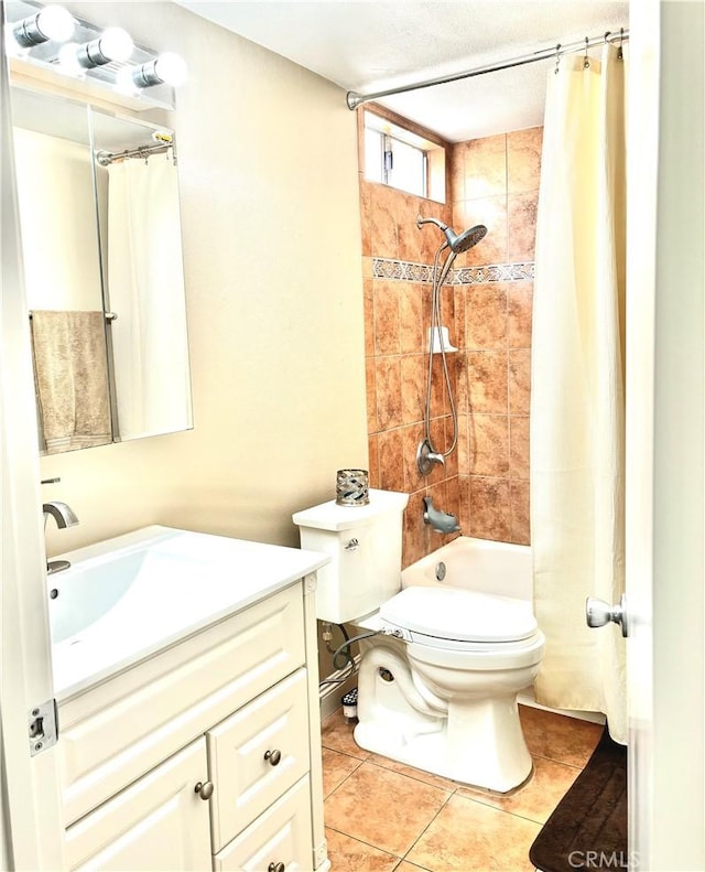 full bath with vanity, tile patterned floors, toilet, and shower / tub combo with curtain
