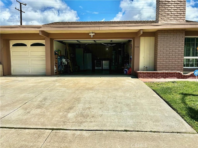 garage with concrete driveway