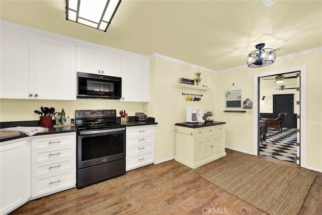 24891 Tehama Vina, Los Molinos, CA 96055 - kitchen with dark countertops, electric range, black microwave, and crown molding