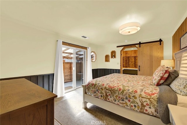 24891 Tehama Vina, Los Molinos, CA 96055 - bedroom featuring access to outside, a barn door, wainscoting, and visible vents