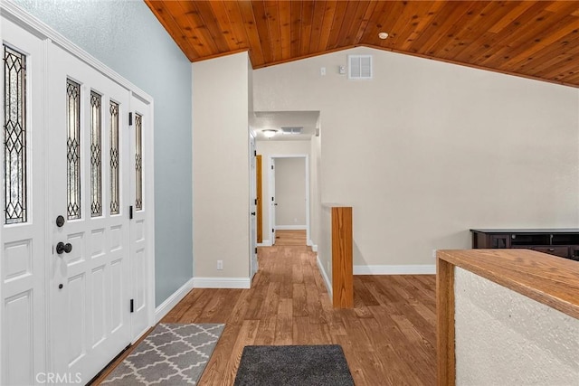 entryway with lofted ceiling, visible vents, wood ceiling, wood finished floors, and baseboards