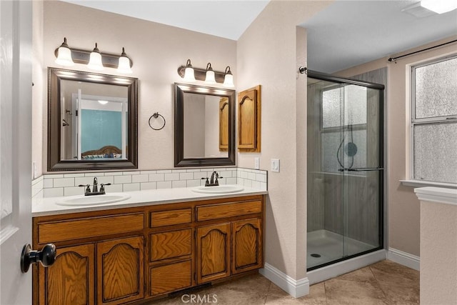 bathroom with a sink, a shower stall, and decorative backsplash