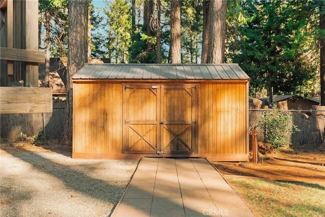 view of shed with fence