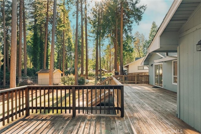 deck featuring an outbuilding and a storage unit