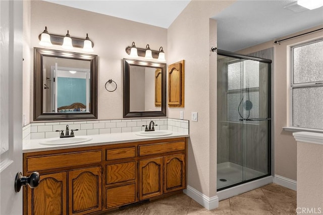 bathroom featuring a stall shower, decorative backsplash, and a sink