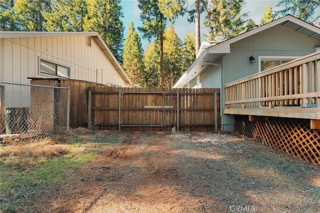 view of yard featuring fence and a wooden deck