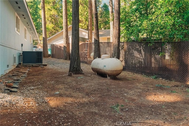 view of yard featuring cooling unit and fence