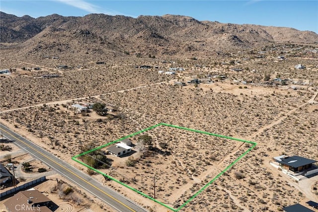 drone / aerial view with view of desert, a rural view, and a mountain view