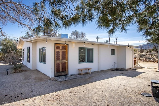 7716 Sunset Rd, Joshua Tree, CA 92252 - rear view of house with stucco siding