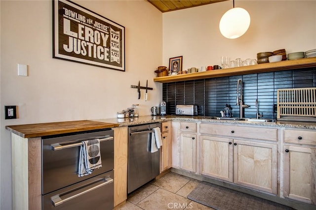 7716 Sunset Rd, Joshua Tree, CA 92252 - kitchen featuring light tile patterned flooring, open shelves, light stone counters, a sink, and stainless steel dishwasher