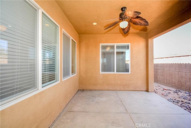 view of patio / terrace with fence and a ceiling fan