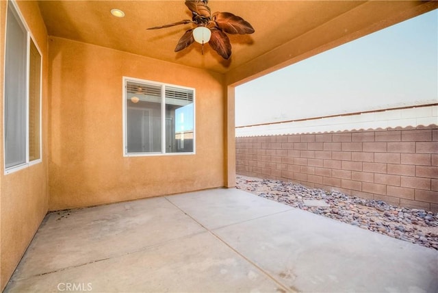 view of patio with fence and ceiling fan