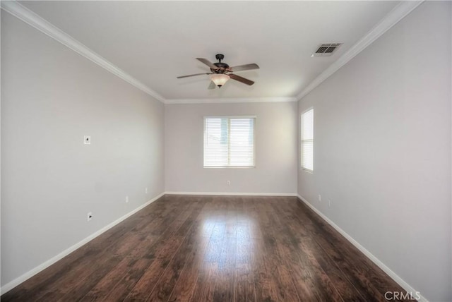 unfurnished room with dark wood-type flooring, visible vents, crown molding, and baseboards