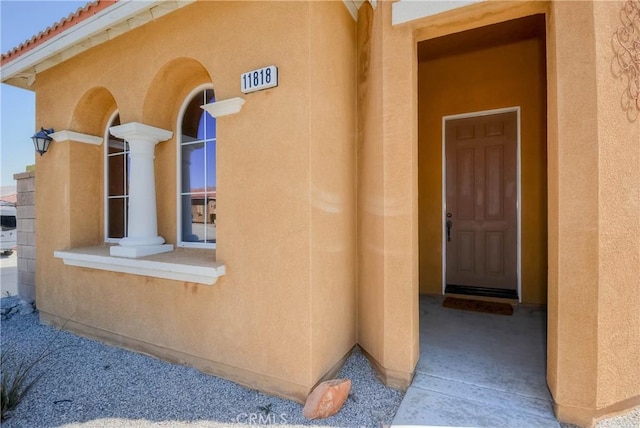 entrance to property with stucco siding