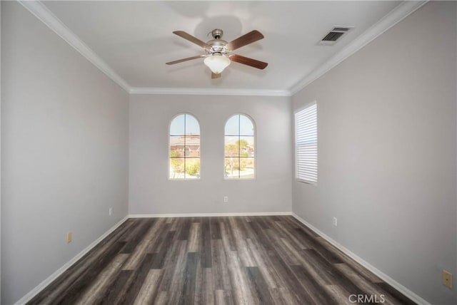 empty room featuring visible vents, crown molding, and baseboards