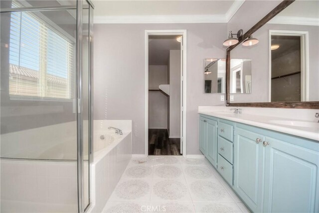 full bathroom featuring a garden tub, double vanity, ornamental molding, a sink, and tile patterned flooring