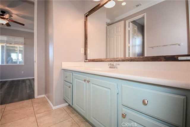 bathroom featuring tile patterned flooring, vanity, visible vents, a ceiling fan, and ornamental molding