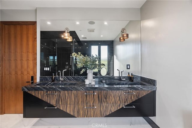 bathroom with recessed lighting, visible vents, and double vanity