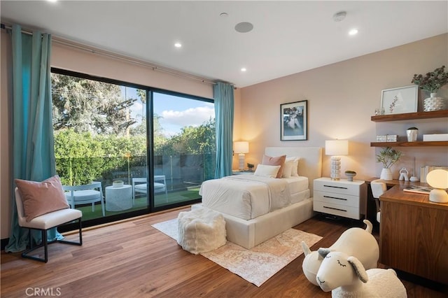 bedroom featuring access to outside, recessed lighting, and wood finished floors