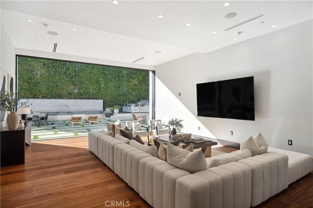 living area featuring recessed lighting, expansive windows, and wood finished floors