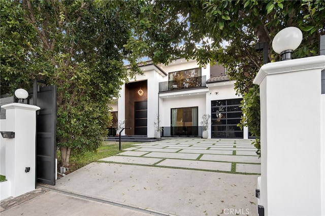 exterior space with a balcony and stucco siding