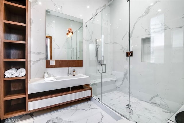 full bath with marble finish floor, vanity, a marble finish shower, and stone wall