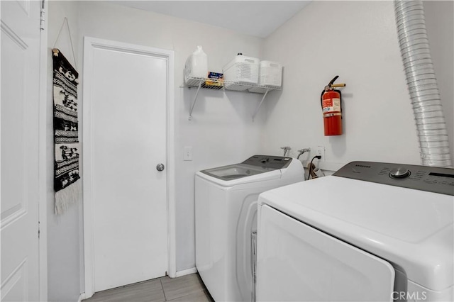 clothes washing area with laundry area and separate washer and dryer