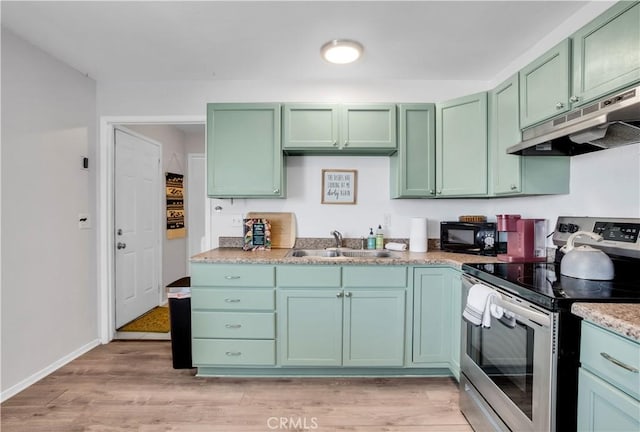 kitchen featuring stainless steel range with electric cooktop, a sink, black microwave, green cabinetry, and under cabinet range hood