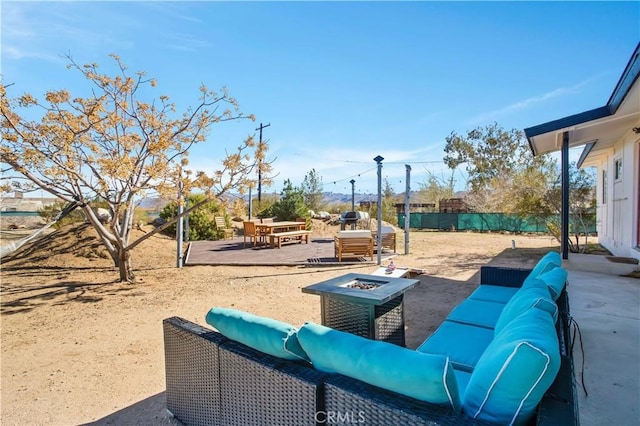 view of patio / terrace with an outdoor living space with a fire pit