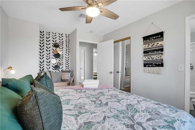 bedroom with visible vents, a ceiling fan, and a textured ceiling