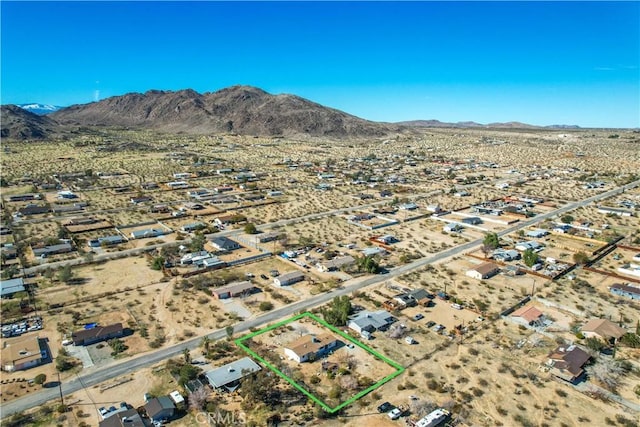 birds eye view of property featuring a desert view and a mountain view