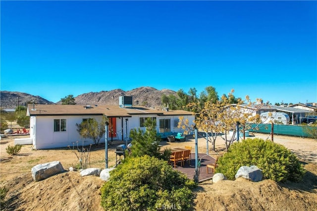 view of front of house featuring a deck with mountain view