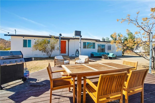 wooden deck featuring an outdoor living space and area for grilling