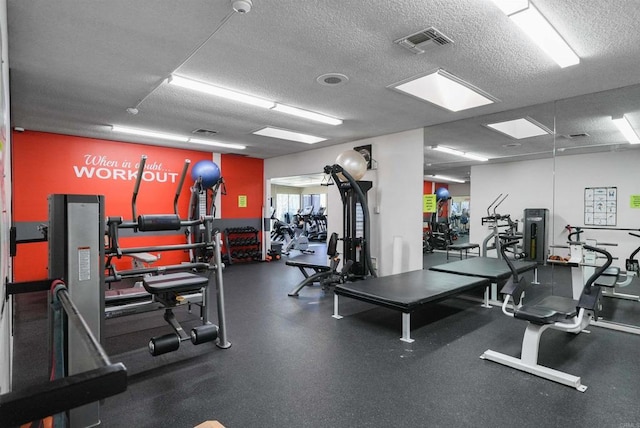 gym featuring visible vents and a textured ceiling