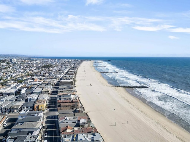 birds eye view of property featuring a beach view and a water view