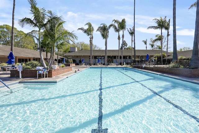 pool featuring fence and a patio