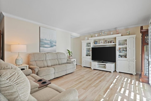 living room with ornamental molding, light wood-style flooring, and baseboards