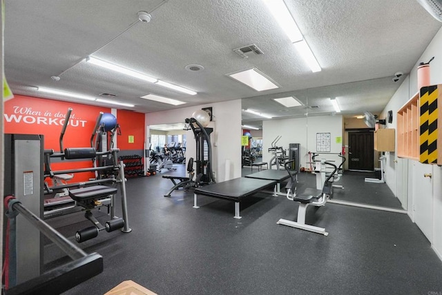 gym featuring a textured ceiling and visible vents