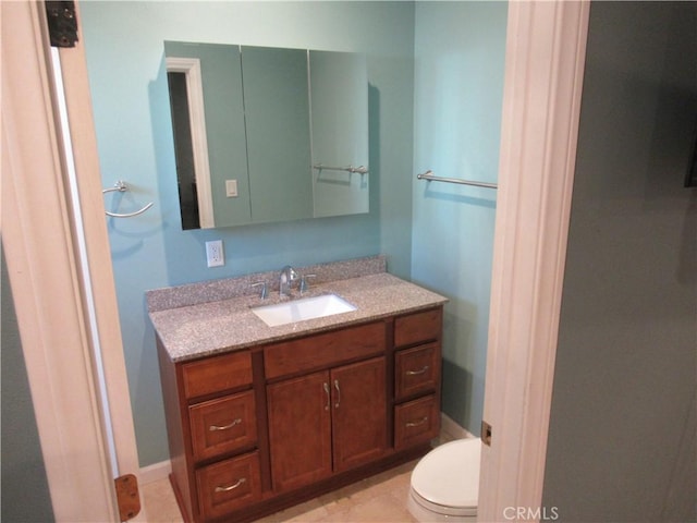 bathroom featuring toilet and vanity