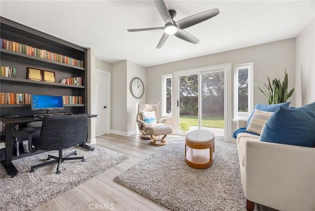 home office featuring ceiling fan, baseboards, and wood finished floors