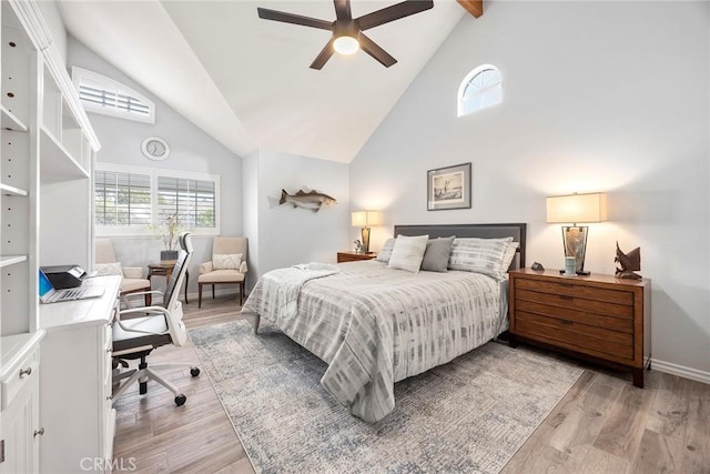 bedroom featuring light wood finished floors, baseboards, high vaulted ceiling, and beamed ceiling