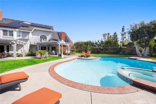 view of swimming pool with a pool with connected hot tub, a patio area, a yard, and a pergola