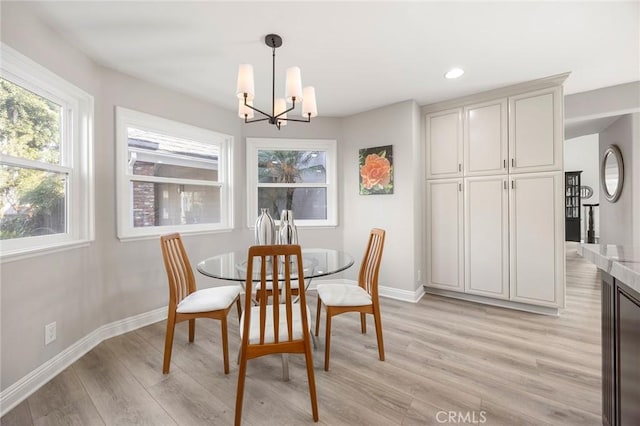 dining room with recessed lighting, light wood-style flooring, baseboards, and an inviting chandelier