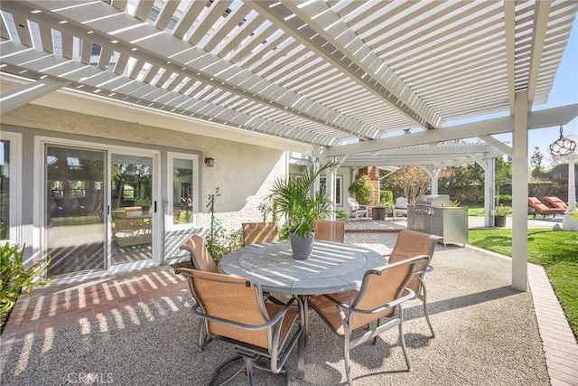 view of patio with exterior kitchen, outdoor dining space, and a pergola