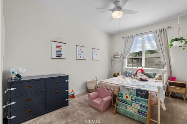 carpeted bedroom featuring ceiling fan and baseboards