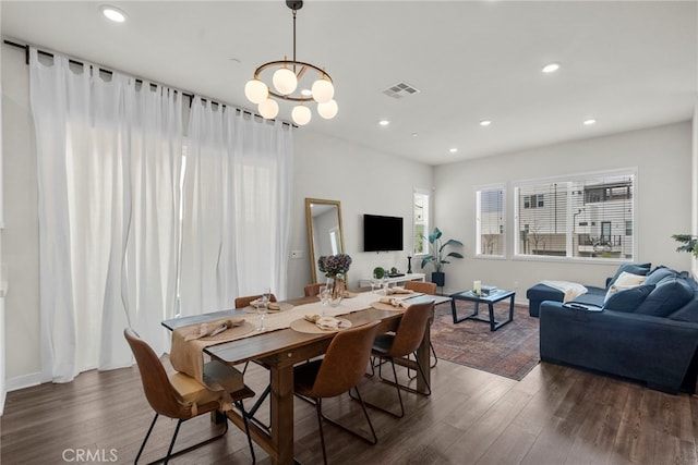 dining space featuring an inviting chandelier, visible vents, wood finished floors, and recessed lighting